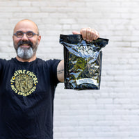 Eric of FF holding 5lb bag of Fortune Favors The Everything