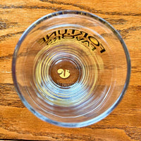 Empty Fortune Favors pint glass showing squirrel logo on the bottom of the glass.