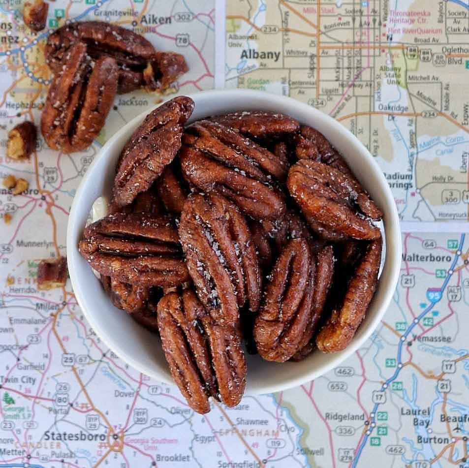 The Gold Candied Pecans in bowl on map of Albany Georgia